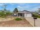 Inviting single-story home with a two-car garage, well-manicured lawn, and charming curb appeal at 3402 S Olathe Way, Aurora, CO 80013