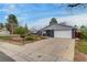Well-maintained home with a long driveway, two-car garage, and landscaped front yard at 3402 S Olathe Way, Aurora, CO 80013