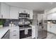 Modern kitchen features stainless steel appliances, subway tile, and quartz counters at 3402 S Olathe Way, Aurora, CO 80013