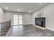 Light-filled living room features fireplace, sliding glass doors, and vinyl plank flooring at 3402 S Olathe Way, Aurora, CO 80013