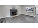 Comfortable living room showcasing fireplace and updated kitchen views at 3402 S Olathe Way, Aurora, CO 80013