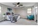 Cozy main bedroom featuring a ceiling fan, plush bedding, and natural light at 3402 S Olathe Way, Aurora, CO 80013