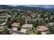Aerial view of the community highlighting numerous houses, trees, and mountain views in the distance at 6379 Spotted Fawn Run, Littleton, CO 80125