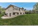 Lush green lawn and landscaped backyard with a view of the rear of the two-story home at 6379 Spotted Fawn Run, Littleton, CO 80125