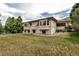 Large backyard featuring an expansive lawn and the home's architecture at 6379 Spotted Fawn Run, Littleton, CO 80125