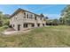 Expansive backyard view with mature trees and home's exterior at 6379 Spotted Fawn Run, Littleton, CO 80125