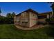 The backyard features well-maintained lawn, mature trees, rock features and a covered patio at 6379 Spotted Fawn Run, Littleton, CO 80125
