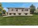 Expansive backyard view of a bright two-story home with large windows and lush green lawn at 6379 Spotted Fawn Run, Littleton, CO 80125