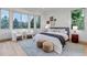 Bedroom with a bay window, sitting area, neutral colors, and natural light at 6379 Spotted Fawn Run, Littleton, CO 80125