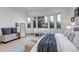Bedroom with a sitting area, bay windows, neutral colors, and ample natural light at 6379 Spotted Fawn Run, Littleton, CO 80125