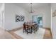 Open dining room featuring modern light fixture and access to a large, private outdoor patio at 6379 Spotted Fawn Run, Littleton, CO 80125