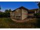 Stucco home featuring a low-pitched tiled roof, a landscaped yard, and numerous windows at 6379 Spotted Fawn Run, Littleton, CO 80125