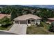 Stunning exterior view of home featuring a tile roof, three-car garage, and lush landscaping at 6379 Spotted Fawn Run, Littleton, CO 80125