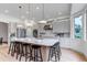 Modern kitchen features large island, stainless appliances, and ample cabinet space at 6379 Spotted Fawn Run, Littleton, CO 80125