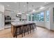 Modern kitchen featuring a large island with seating, quartz countertops, and stainless steel appliances at 6379 Spotted Fawn Run, Littleton, CO 80125