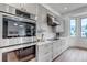 Well-appointed kitchen with stainless steel appliances and sleek white cabinets at 6379 Spotted Fawn Run, Littleton, CO 80125