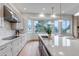 Bright, open kitchen with marble countertops, stainless steel appliances, and a large island at 6379 Spotted Fawn Run, Littleton, CO 80125