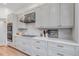 Gourmet kitchen features stainless steel appliances, sleek white cabinets, and quartz countertops at 6379 Spotted Fawn Run, Littleton, CO 80125