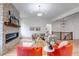 Bright living room with stone fireplace, hardwood floors, and comfortable seating at 6379 Spotted Fawn Run, Littleton, CO 80125