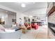 Spacious living room with stone fireplace and open-concept kitchen at 6379 Spotted Fawn Run, Littleton, CO 80125