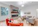 Bright living room with stone fireplace, hardwood floors, and oversized windows at 6379 Spotted Fawn Run, Littleton, CO 80125