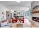 Open concept living room featuring a stone fireplace and seamlessly connected kitchen at 6379 Spotted Fawn Run, Littleton, CO 80125