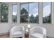 Sitting area with large windows and two chairs at 6379 Spotted Fawn Run, Littleton, CO 80125