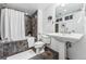 Bathroom featuring a shower and bathtub with mosaic tile and a pedestal sink at 721 Monroe St, Denver, CO 80206