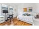 Bright bedroom featuring a desk, hardwood floors, and white walls at 721 Monroe St, Denver, CO 80206