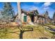 Quaint brick home on a well-manicured lawn featuring a covered front porch and fresh green grass at 721 Monroe St, Denver, CO 80206