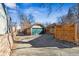 View of a detached garage with a green door and a concrete driveway at 721 Monroe St, Denver, CO 80206