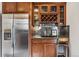 Kitchen featuring stainless steel refrigerator, wine rack, and glassware storage at 721 Monroe St, Denver, CO 80206