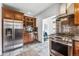 Modern kitchen with stainless steel appliances, tile flooring, and a wine storage area at 721 Monroe St, Denver, CO 80206