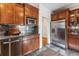 Kitchen with stainless steel appliances, wood cabinets, and tiled backsplash at 721 Monroe St, Denver, CO 80206