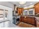 Well-lit kitchen featuring stainless steel appliances, wood cabinets, and granite countertops at 721 Monroe St, Denver, CO 80206