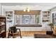 Bright living room features a large window seat with storage, built-in shelves, and hardwood floors at 721 Monroe St, Denver, CO 80206