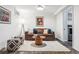 Inviting living room with a comfortable brown sofa, stylish ottomans, and a cozy rug at 721 Monroe St, Denver, CO 80206