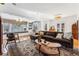 Spacious living room with a large window, comfortable brown sectional, and hardwood floors at 721 Monroe St, Denver, CO 80206