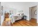 Bright bedroom with hardwood floors, dresser, and white walls at 721 Monroe St, Denver, CO 80206