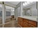 Bathroom featuring a vanity with wood cabinets, a mirror, and a view into the bedroom at 13991 E Marina Dr # 505, Aurora, CO 80014