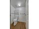 Compact bathroom featuring white fixtures, light wood-look flooring, and a storage cabinet at 13991 E Marina Dr # 505, Aurora, CO 80014
