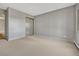 Neutral bedroom featuring soft carpet, a mirrored closet, and a view to the bath area at 13991 E Marina Dr # 505, Aurora, CO 80014