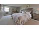 Cozy bedroom with a large floral patterned quilt, wooden headboard, and natural light at 13991 E Marina Dr # 505, Aurora, CO 80014