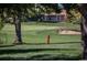 Picturesque view of the golf course with lush green grass, sand traps, and a distant home at 13991 E Marina Dr # 505, Aurora, CO 80014
