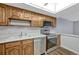 The kitchen features ample cabinetry, stainless steel appliances, and wood-look floors at 13991 E Marina Dr # 505, Aurora, CO 80014
