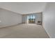 Bright and airy living room with neutral carpet, sliding glass doors to balcony and an A/C unit at 13991 E Marina Dr # 505, Aurora, CO 80014