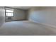 Bright and airy living room features neutral carpet and a large window with radiator below at 13991 E Marina Dr # 505, Aurora, CO 80014