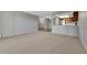 Spacious living room showing view to open kitchen, neutral carpet, and access to other rooms at 13991 E Marina Dr # 505, Aurora, CO 80014