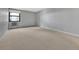 Well-lit living room features neutral carpet and a large window with radiator below at 13991 E Marina Dr # 505, Aurora, CO 80014