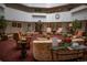 A bright lobby with comfortable seating arrangements, plants, artwork, and a visible clock at 13991 E Marina Dr # 505, Aurora, CO 80014